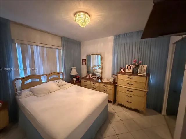 a bed room with a bed mirror and a desk