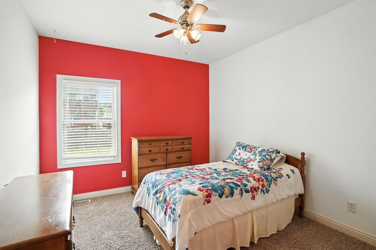 183 West 126th Place Crown Point, IN 46307 - Photo 16 of 25 a bedroom with a bed and a chandelier
