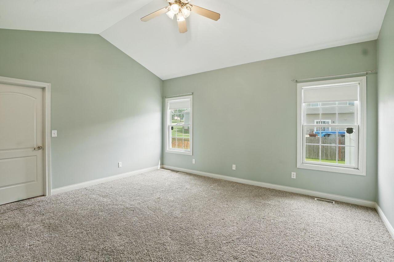 183 West 126th Place Crown Point, IN 46307 - Photo 3 of 25 an empty room with chandelier fan and windows