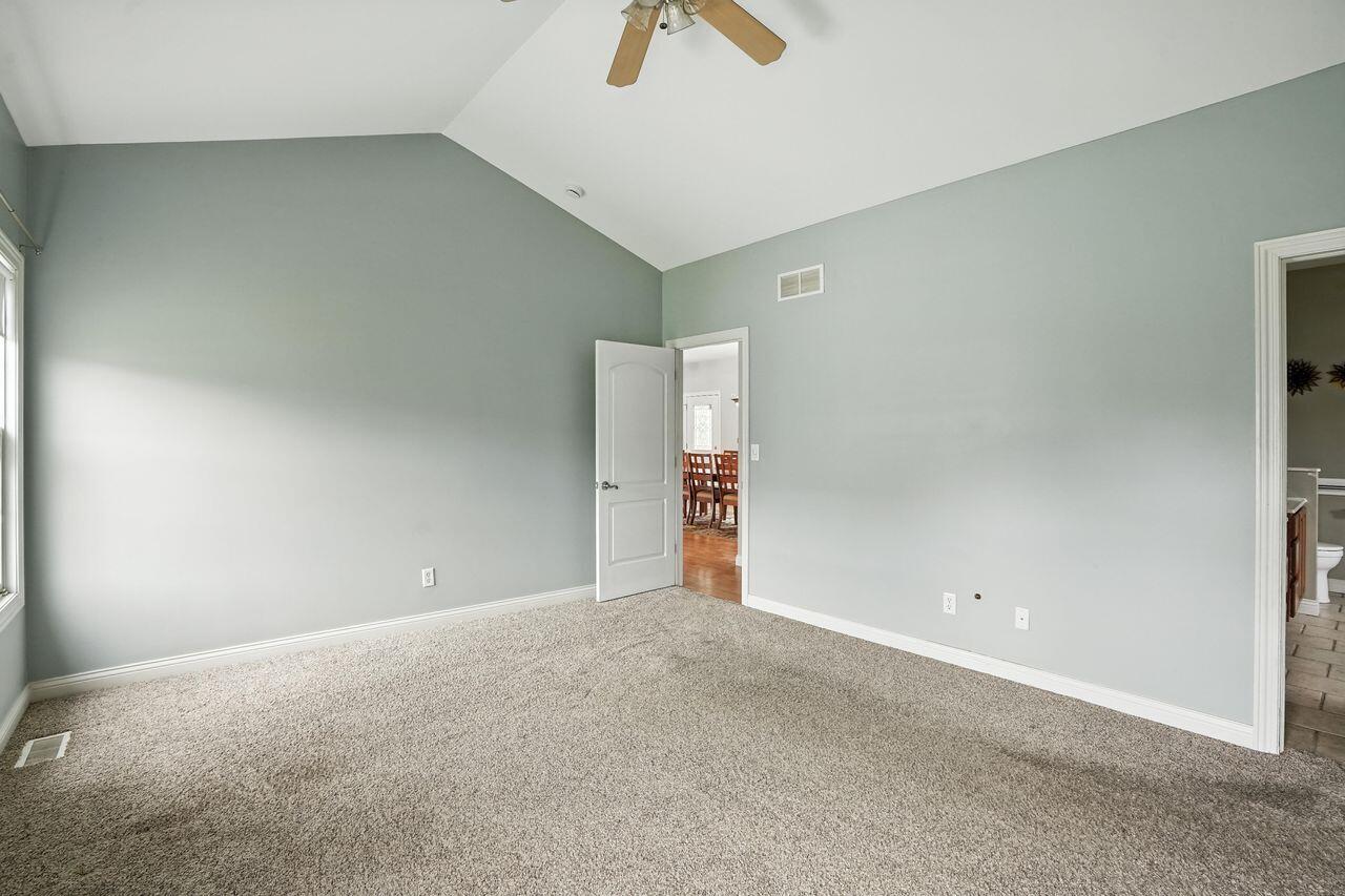 183 West 126th Place Crown Point, IN 46307 - Photo 4 of 25 an empty room with an entryway and chandelier fan