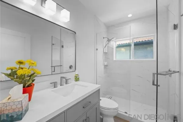 a bathroom with a sink toilet and shower