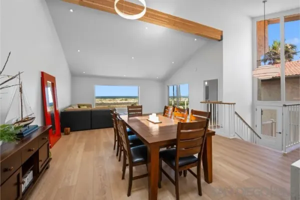 a view of a dining room with furniture and a flat screen tv