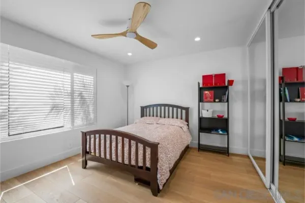 a bed room with a bed and a ceiling fan