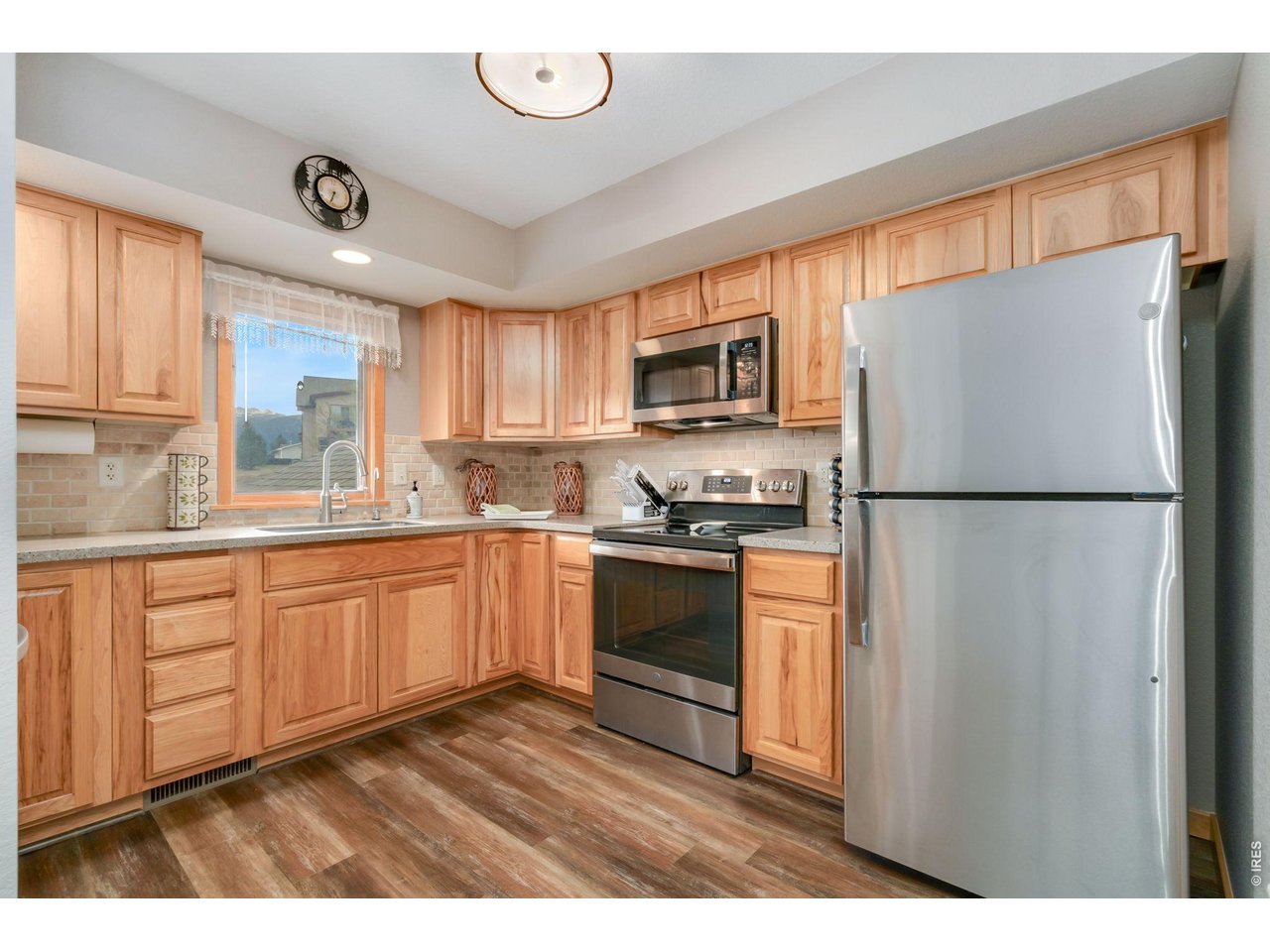 1761 Wildfire Road Estes Park, CO 80517 - Photo 11 of 45 a kitchen with kitchen island granite countertop stainless steel appliances cabinets a sink and a large window