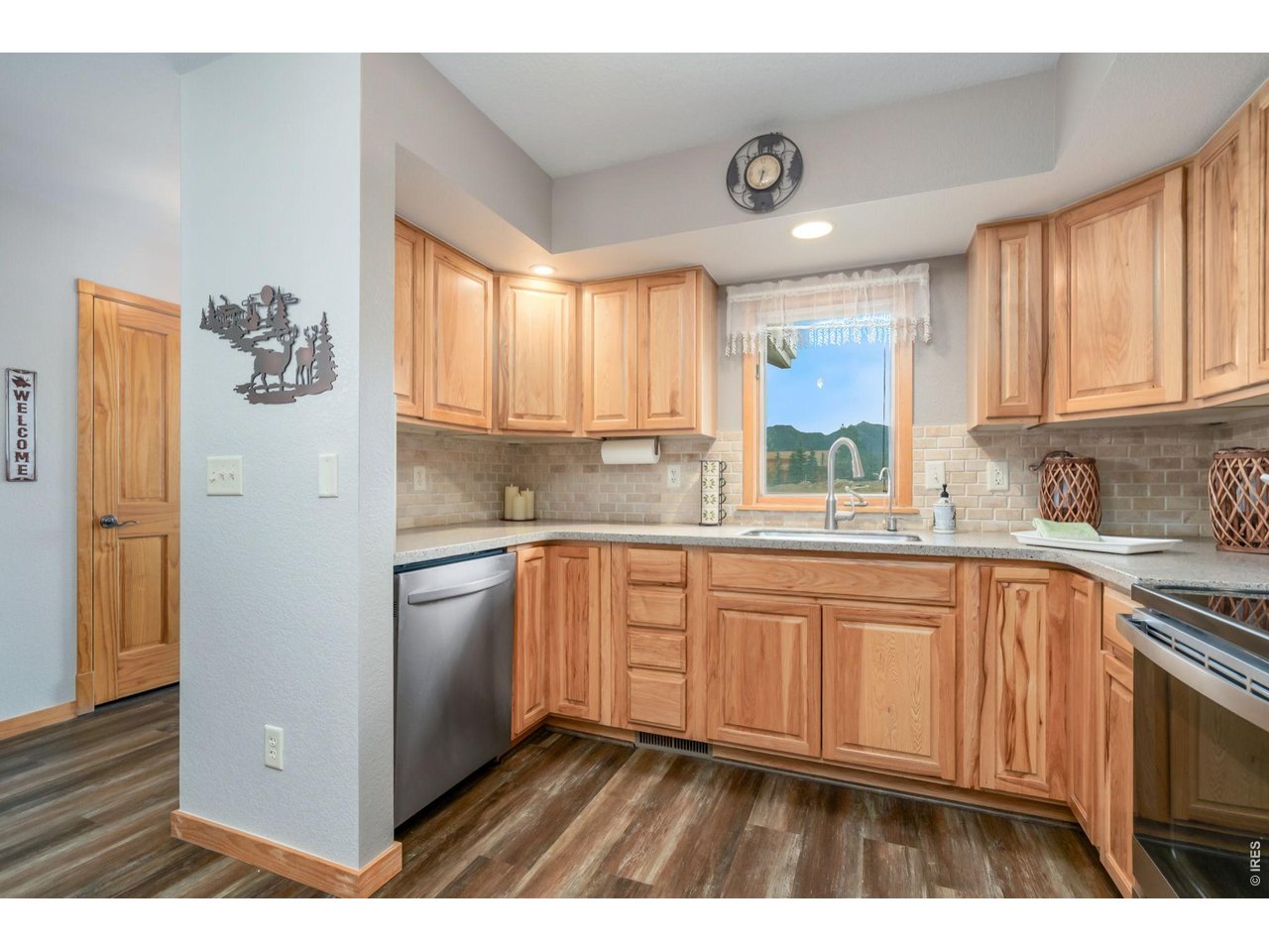 1761 Wildfire Road Estes Park, CO 80517 - Photo 12 of 45 a kitchen with granite countertop white cabinets and white appliances
