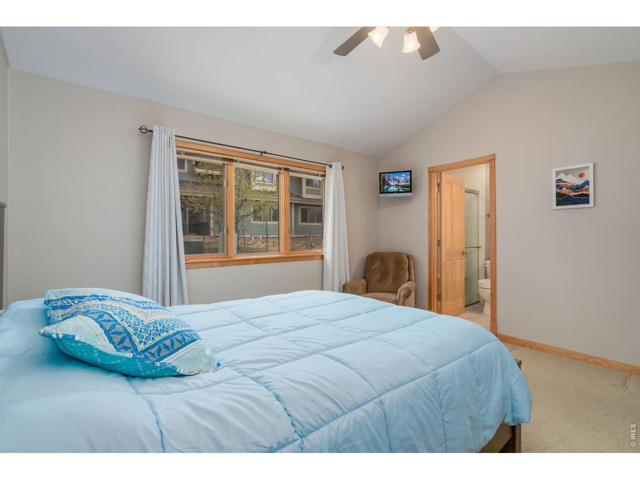 1761 Wildfire Road Estes Park, CO 80517 - Photo 20 of 45 a bedroom with a bed and a large window