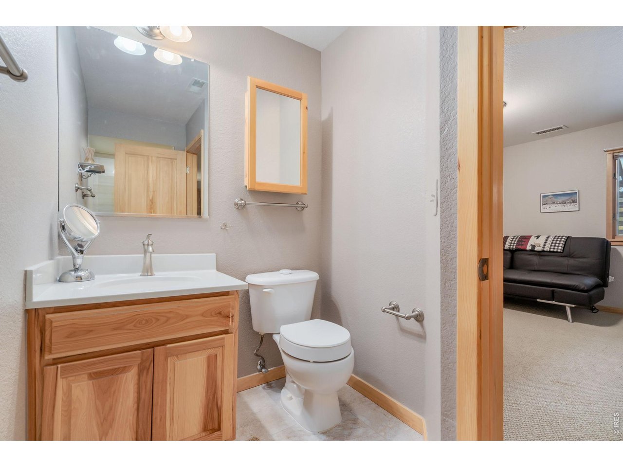 1761 Wildfire Road Estes Park, CO 80517 - Photo 30 of 45 a bathroom with a toilet a sink and a mirror