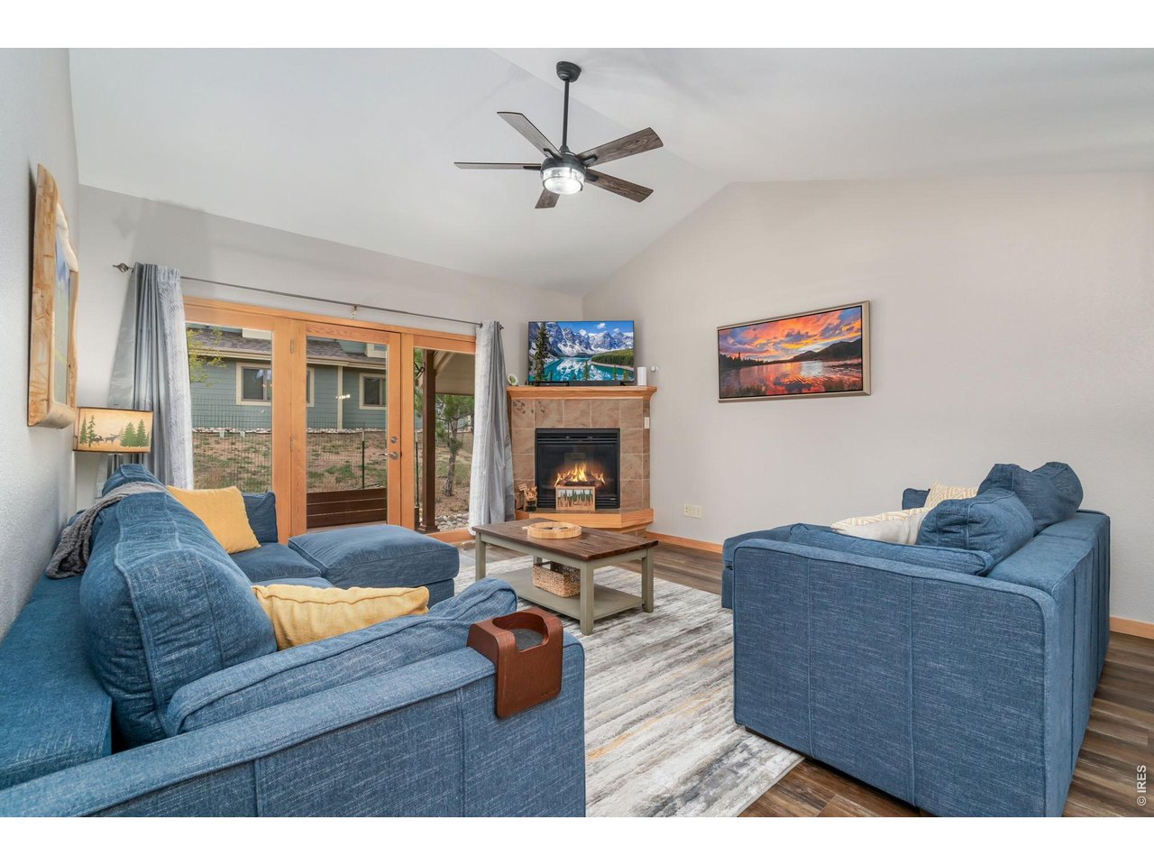 1761 Wildfire Road Estes Park, CO 80517 - Photo 7 of 45 a living room with furniture and a fireplace