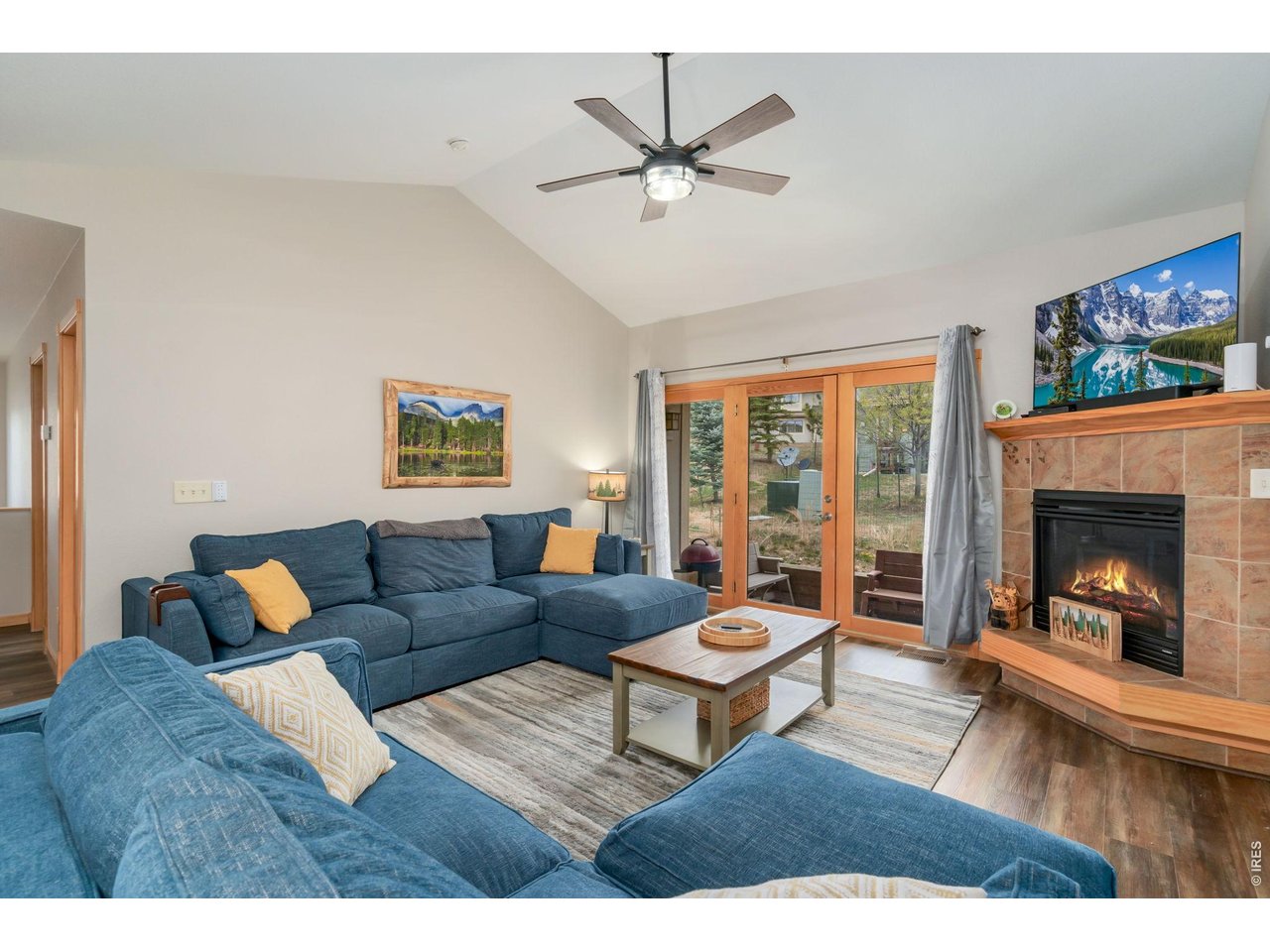 1761 Wildfire Road Estes Park, CO 80517 - Photo 10 of 45 a living room with furniture and a fireplace