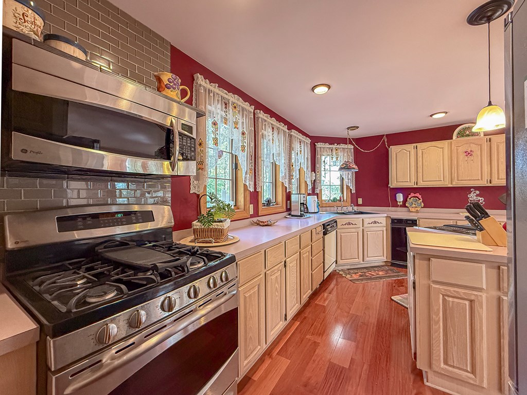 13581 Solitude Trail Machipongo, VA 23405 - Photo 13 of 51 a kitchen with a stove a sink and a refrigerator