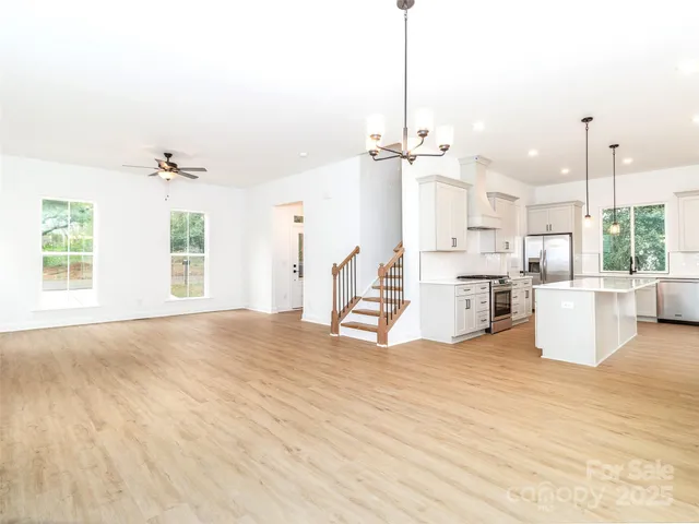 a view of a kitchen with furniture and a ceiling fan
