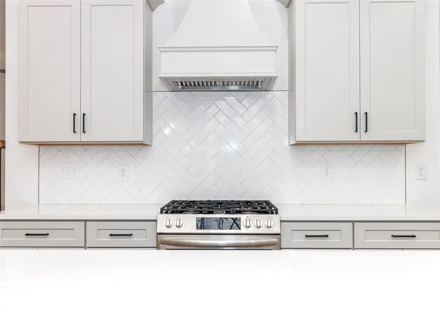 a kitchen with a stove and a white cabinet