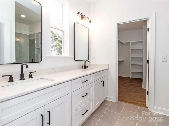 a bathroom with a double vanity sink and mirror