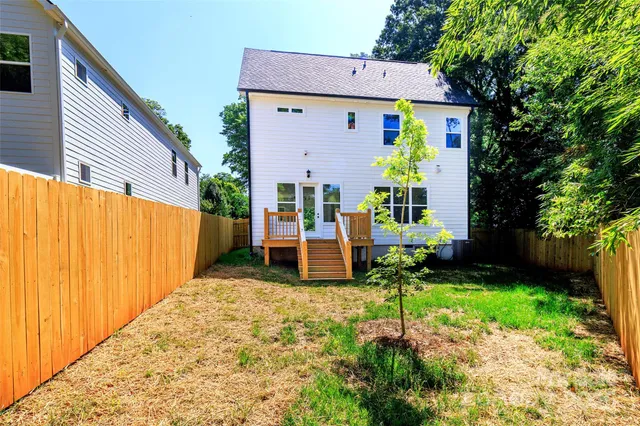 a view of a chair and table in backyard of the house