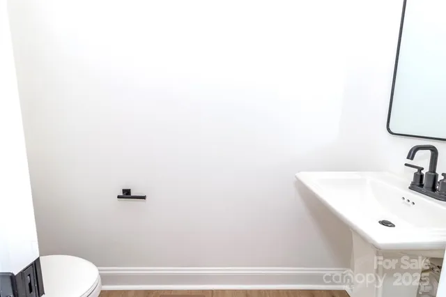 a bathroom with a sink a toilet and mirror