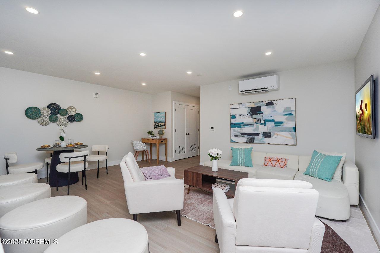 27 3rd Avenue, Unit 210 Long Branch, NJ 07740 - Photo 11 of 28 a living room with furniture and a wooden floor