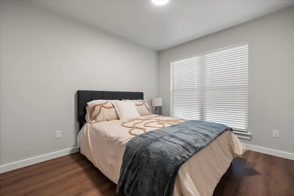 a bedroom with a bed and a night stand