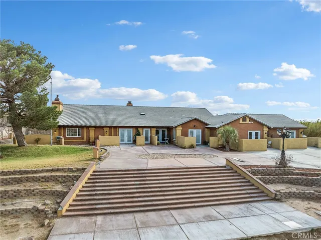 a view of a house with a yard and street view