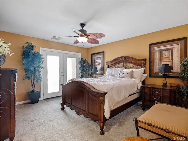 a bed room with a bed and a chandelier