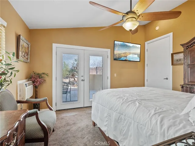 a view of swimming pool with lawn chairs and wooden fence