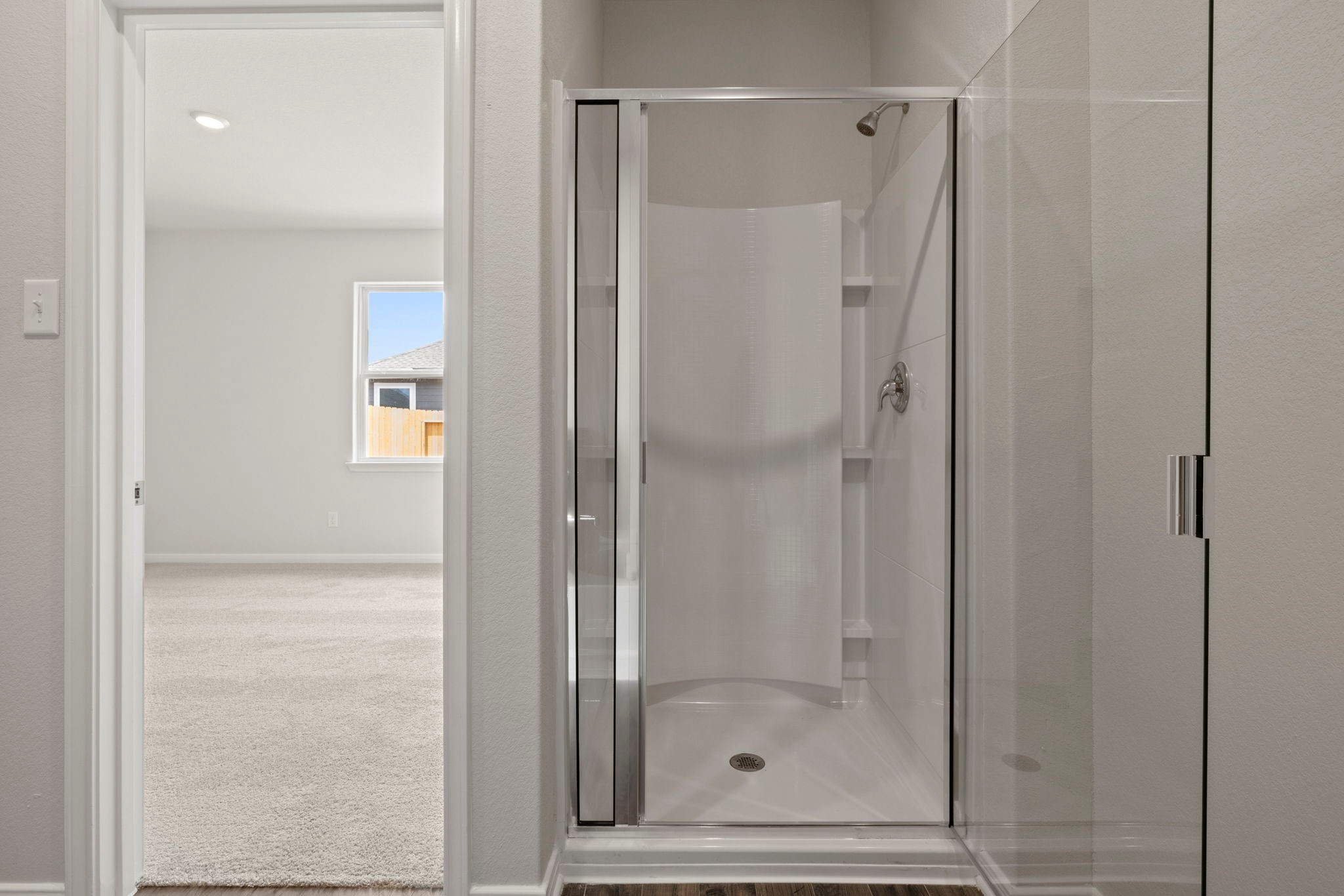 7610 Thrips Lane Richmond, TX 77469 - Photo 12 of 20 a bathroom with a glass shower door