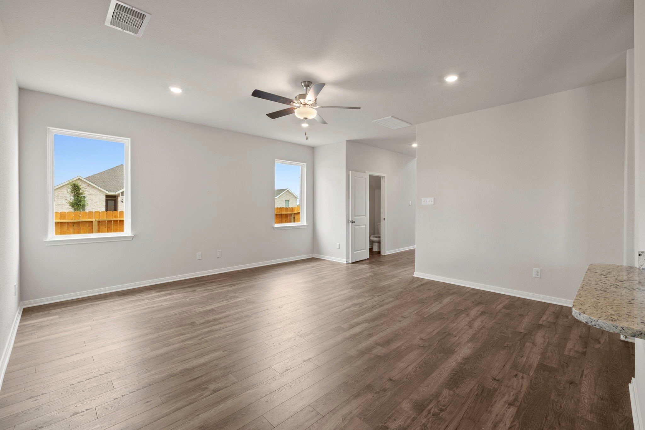 7610 Thrips Lane Richmond, TX 77469 - Photo 13 of 20 wooden floor in an empty room with a window