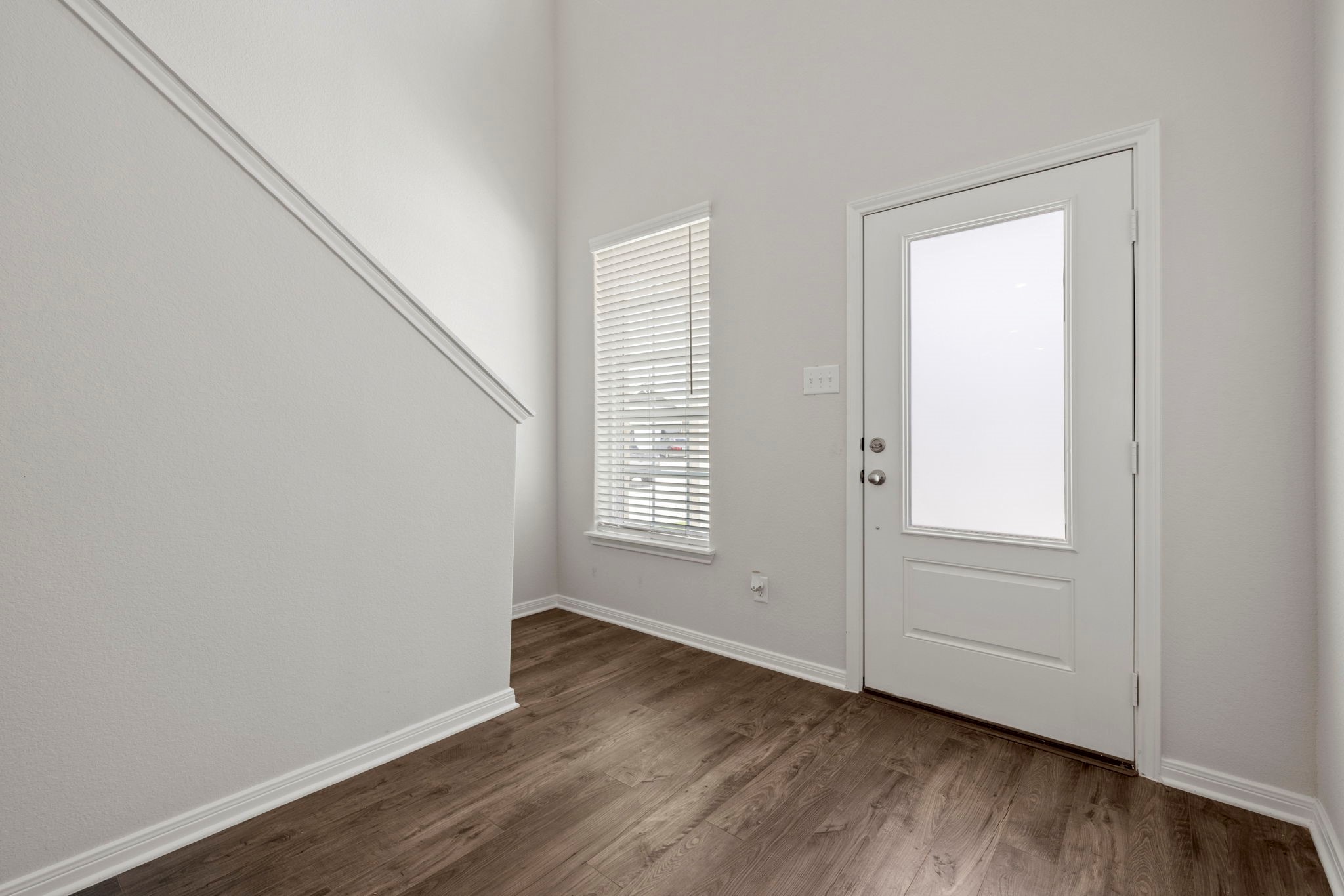 7610 Thrips Lane Richmond, TX 77469 - Photo 2 of 20 an empty room with wooden floor and windows