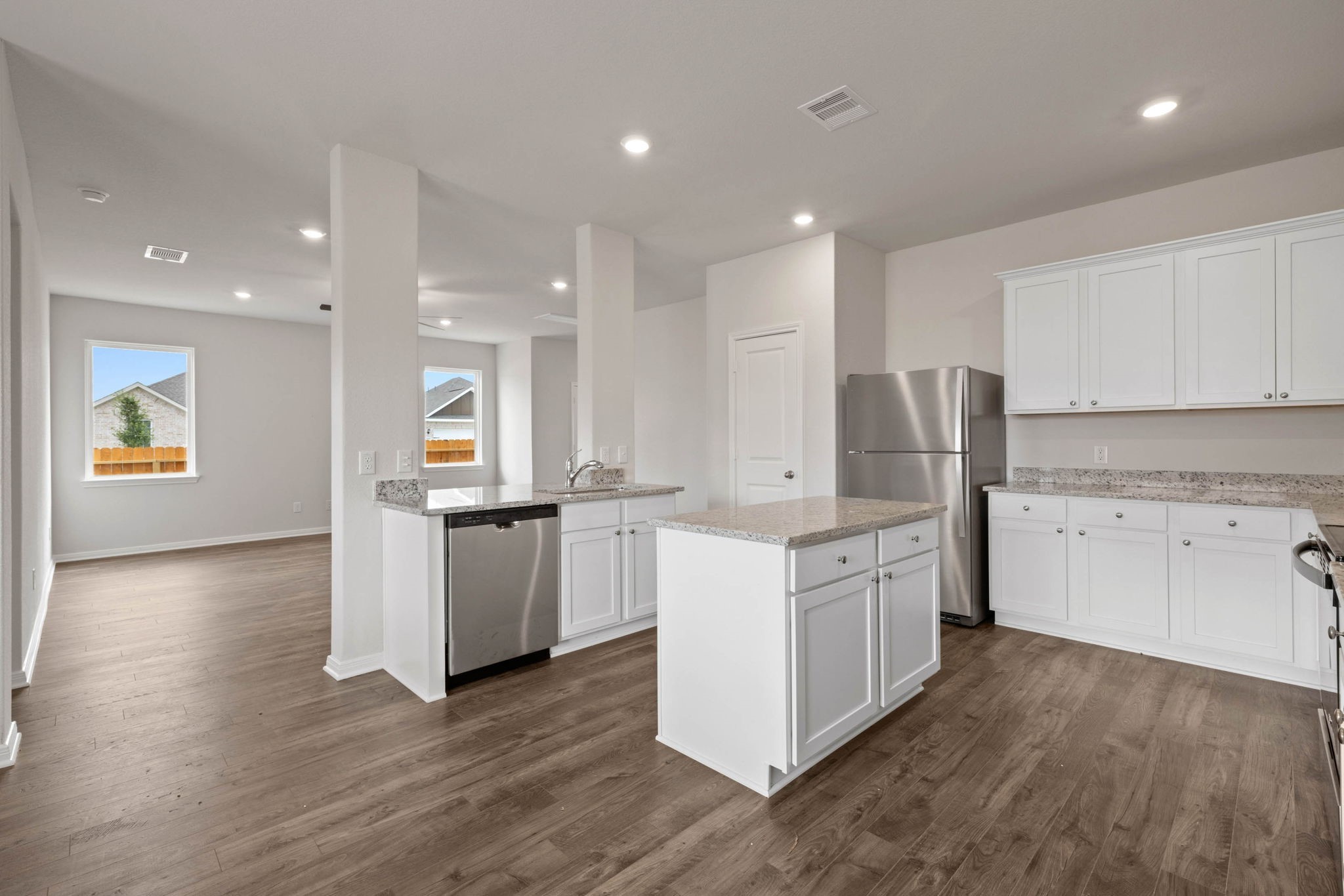 7610 Thrips Lane Richmond, TX 77469 - Photo 5 of 20 a kitchen with white cabinets and stainless steel appliances