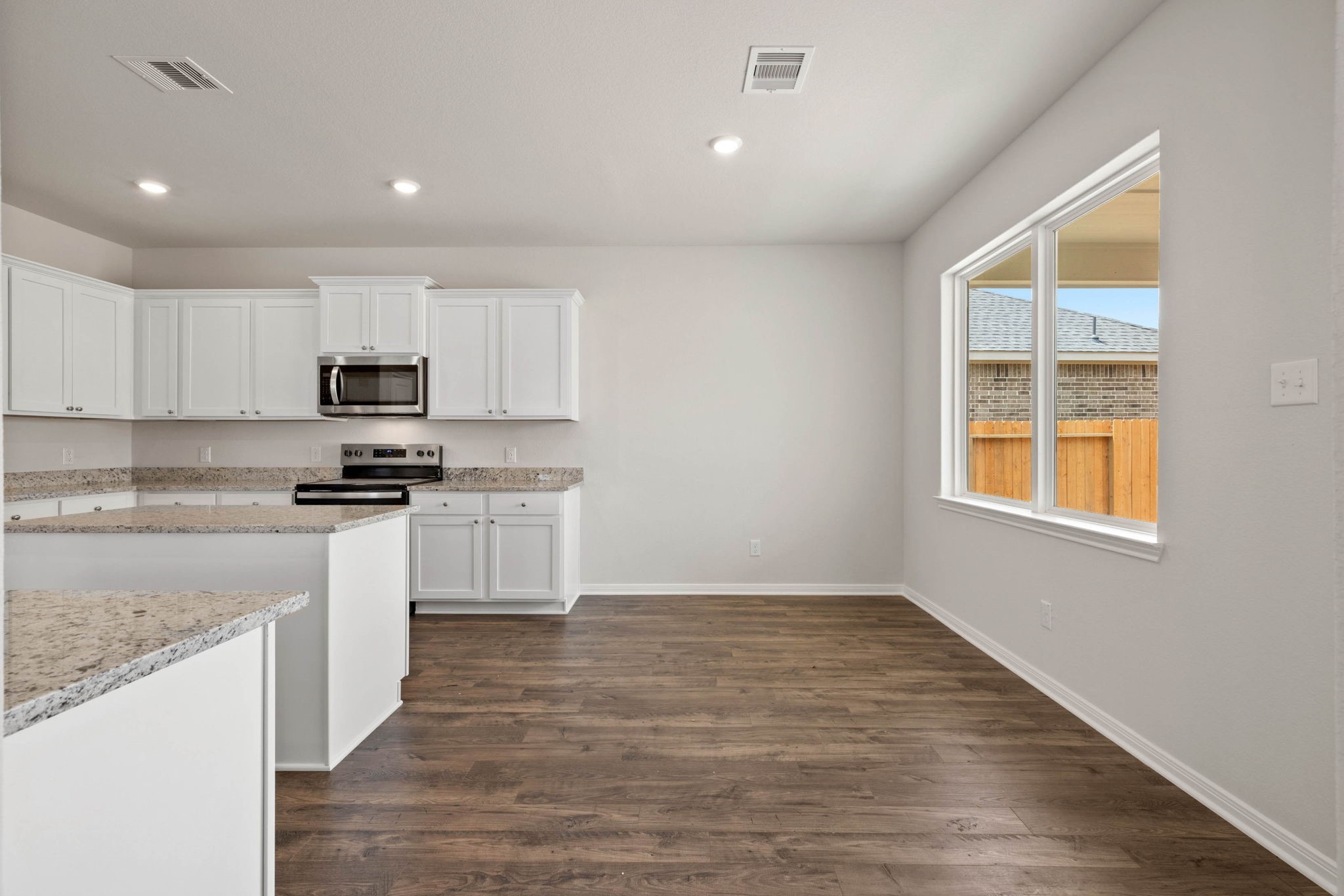 7610 Thrips Lane Richmond, TX 77469 - Photo 8 of 20 a kitchen with granite countertop white cabinets and black stainless steel appliances