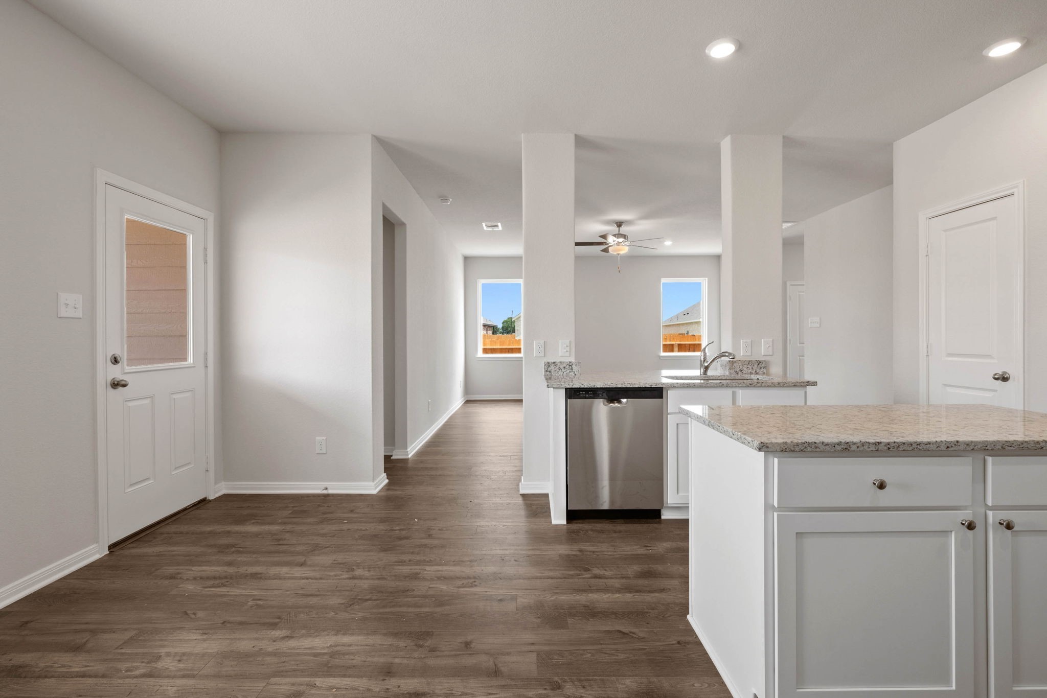 7610 Thrips Lane Richmond, TX 77469 - Photo 9 of 20 a view of kitchen with center island wooden floor and view living room