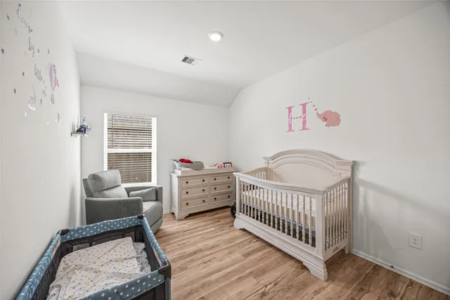 a bedroom with furniture and a window