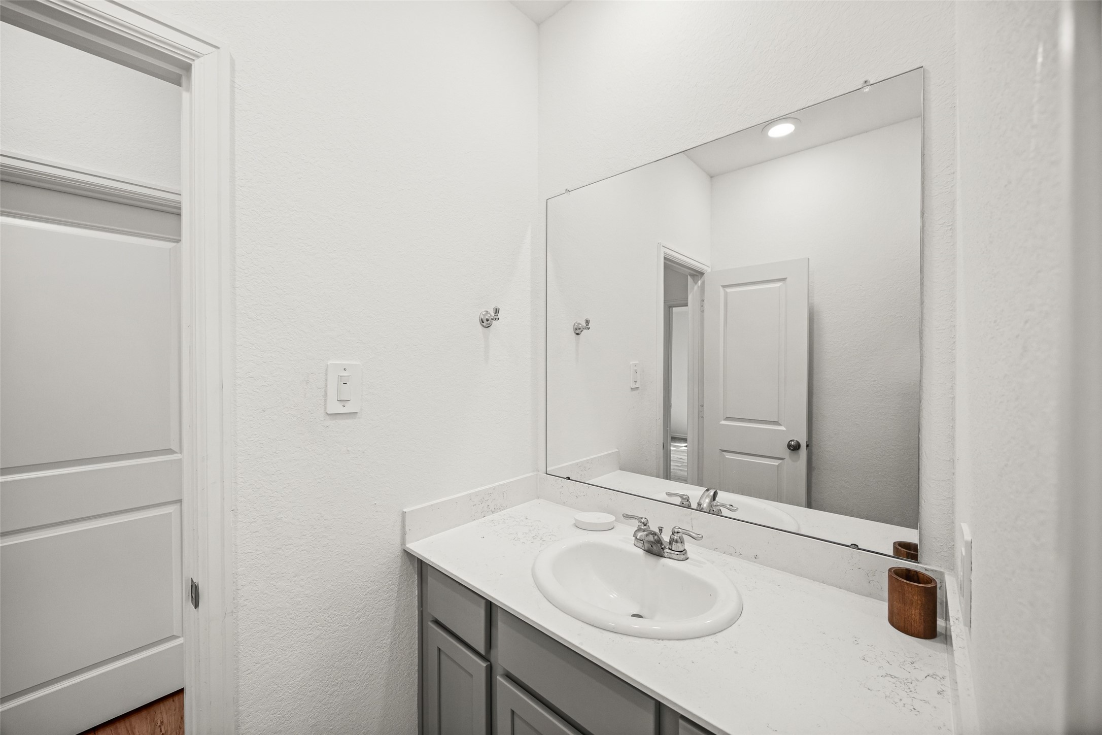 2822 Paradise Ridge Way Conroe, TX 77301 - Photo 17 of 21 a bathroom with a sink and a mirror