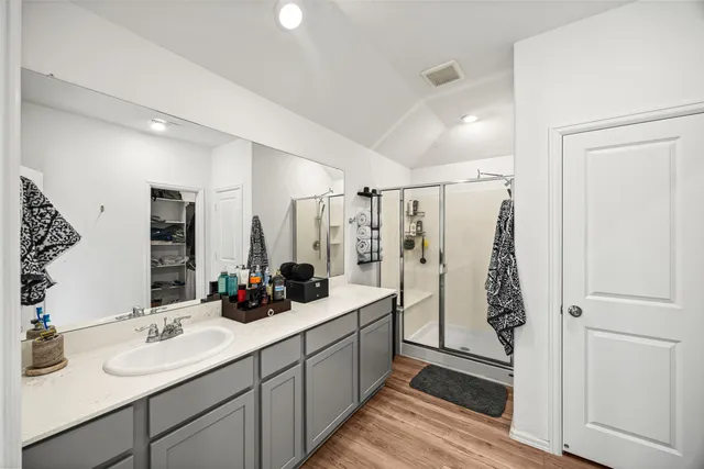 a bathroom with a double vanity sink and mirror