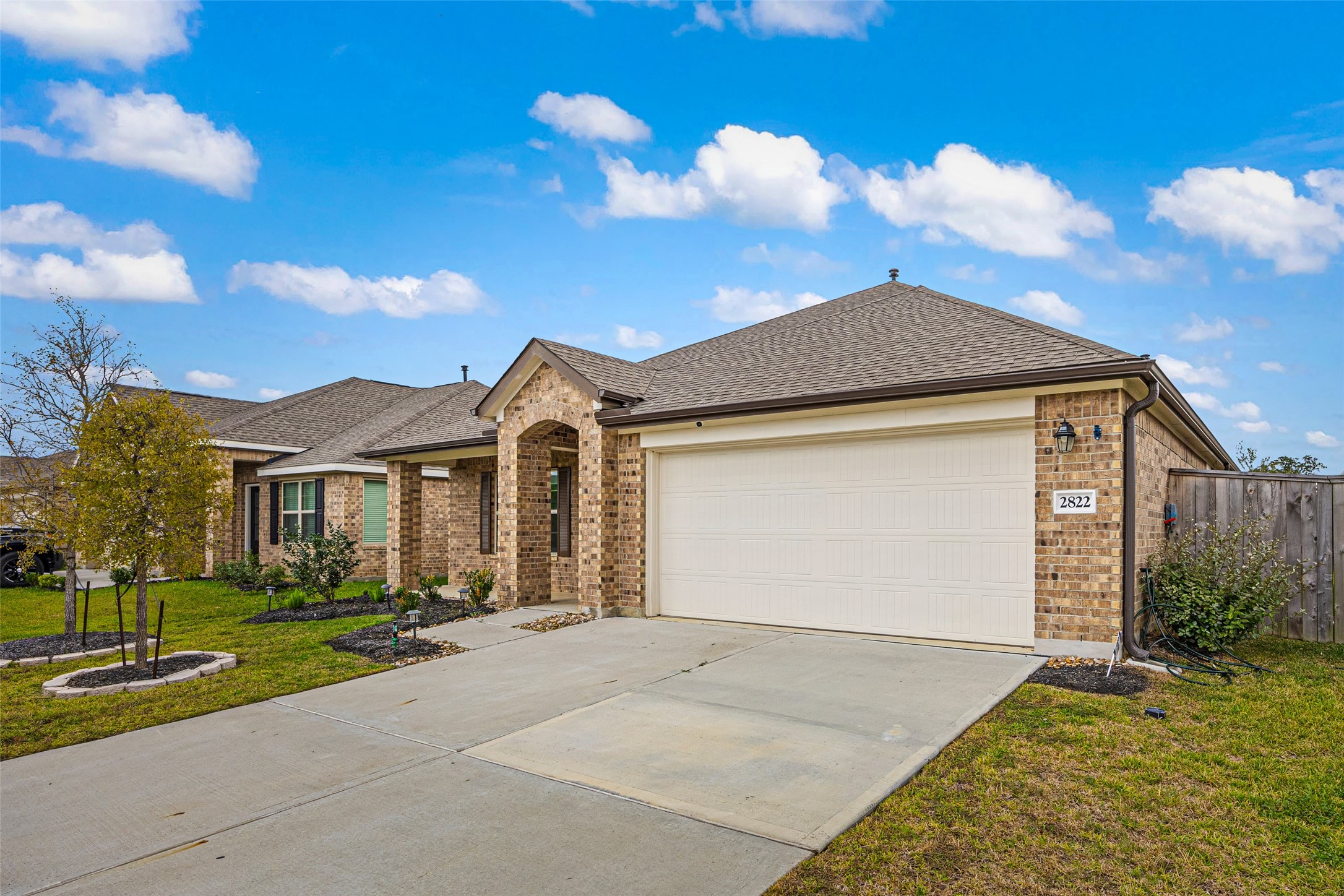 2822 Paradise Ridge Way Conroe, TX 77301 - Photo 2 of 21 a front view of a house with a yard and garage