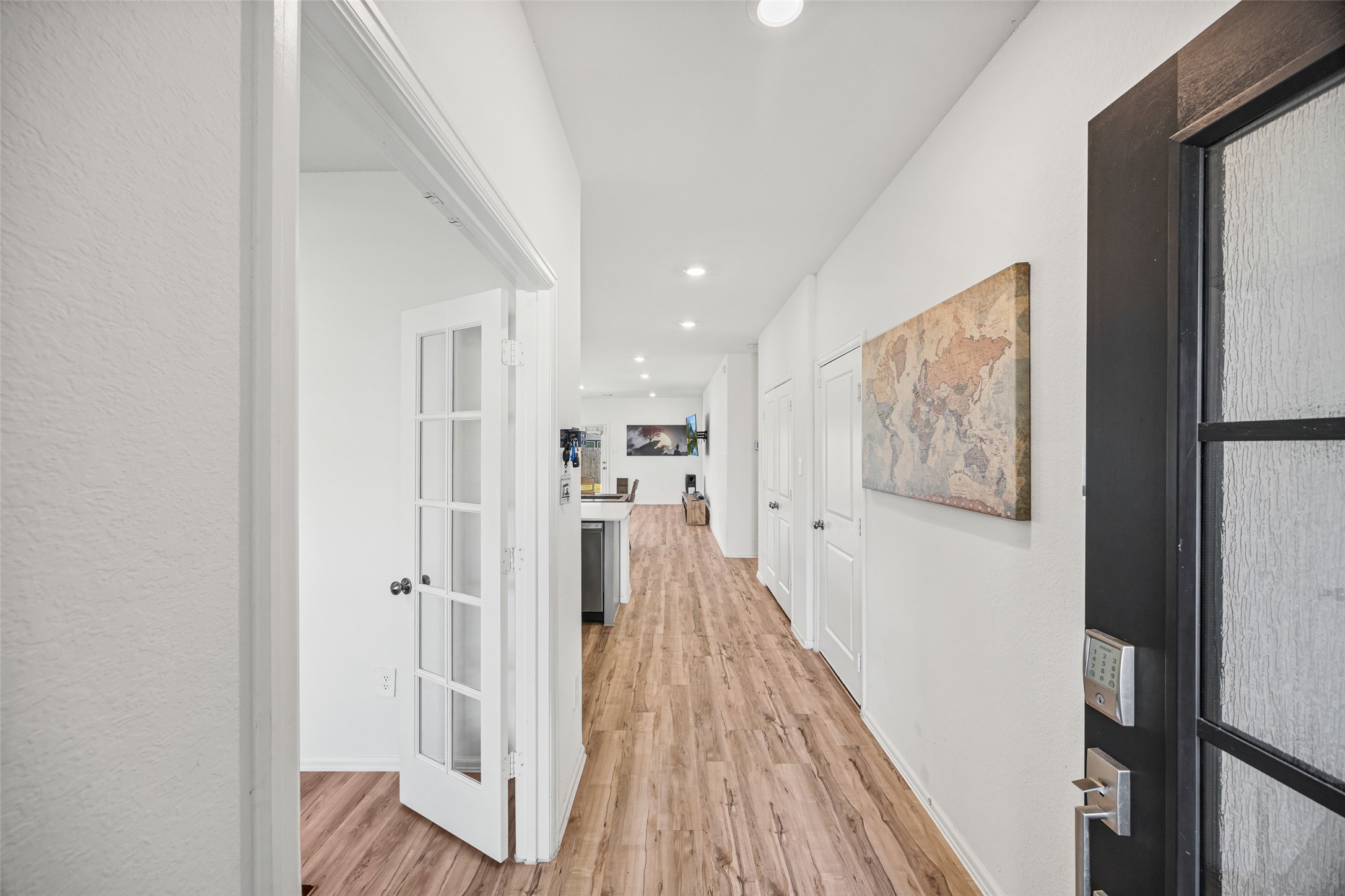 2822 Paradise Ridge Way Conroe, TX 77301 - Photo 5 of 21 a view of a hallway with wooden floor and staircase
