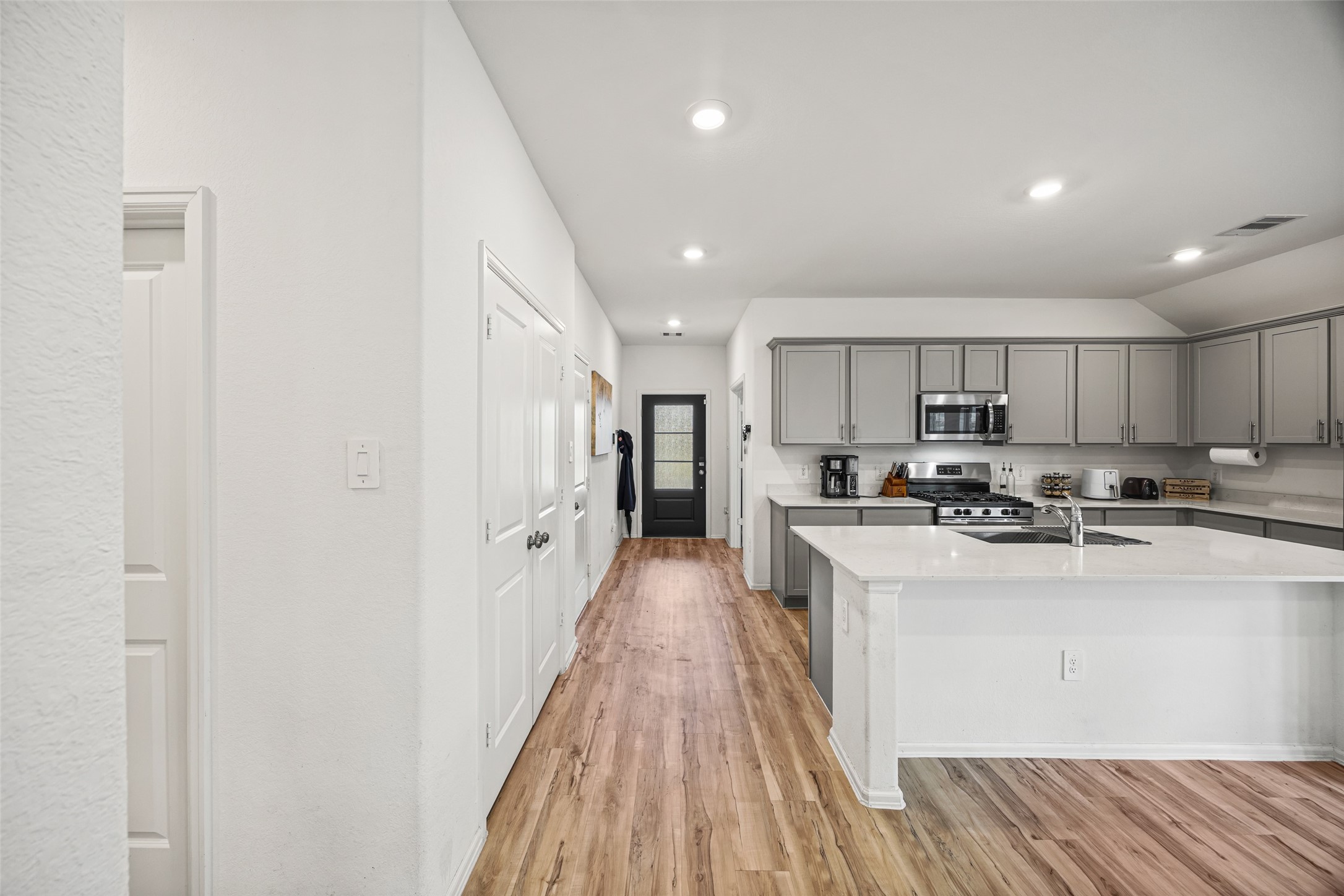 2822 Paradise Ridge Way Conroe, TX 77301 - Photo 7 of 21 a view of a kitchen with kitchen island a sink a stove and refrigerator