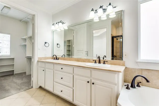a bathroom with a double vanity sink mirror and