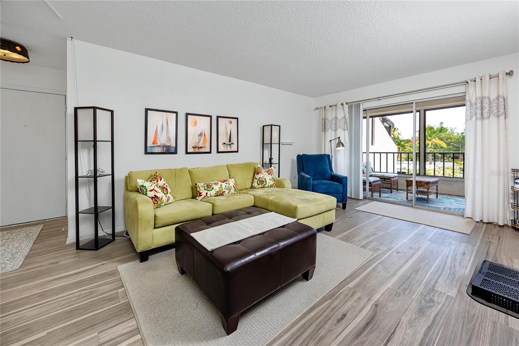 2207 Belleair Road, Unit B30 Clearwater, FL 33764 - Photo 9 of 39 a living room with furniture and a wooden floor