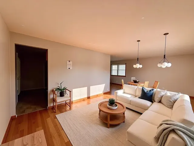 a living room with furniture a rug and a lamp