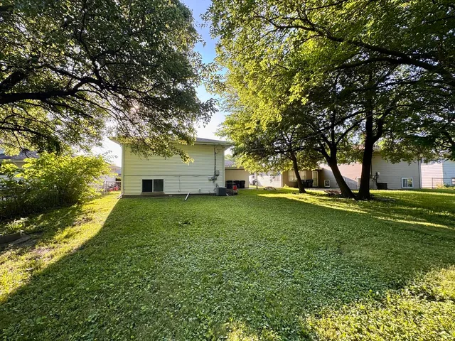 a view of a house with a backyard