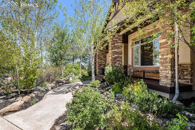 a living room with furniture kitchen view and a wooden floor
