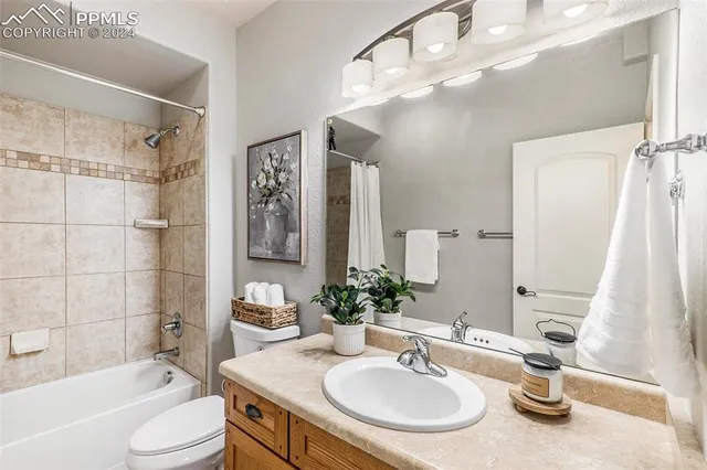 a front view of a house with a garden and a yard