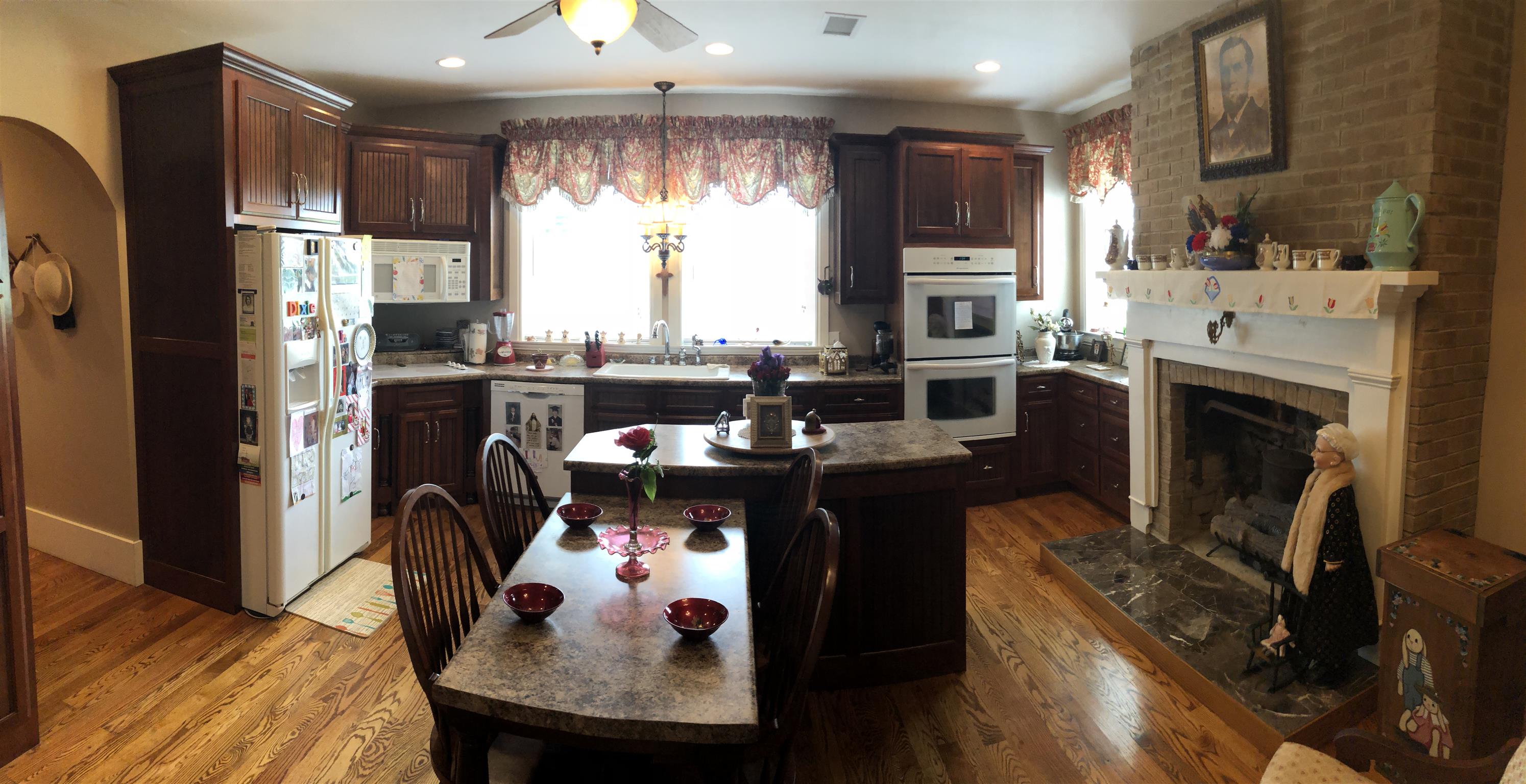 1108 Steele Road Franklin, KY 42134 - Photo 13 of 20 a kitchen with stainless steel appliances granite countertop a refrigerator a stove a sink dishwasher a dining table and chairs with wooden floor