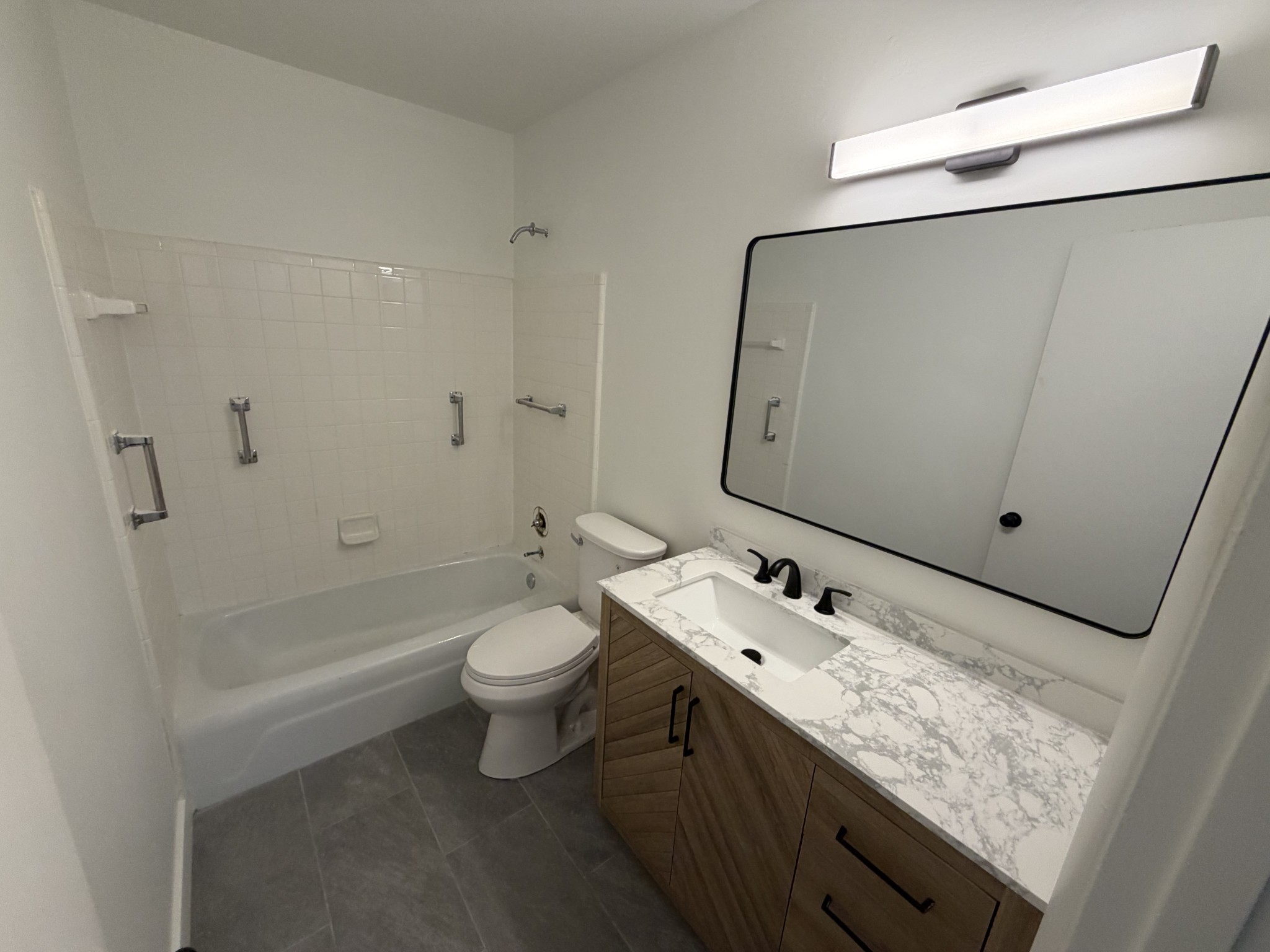1100 West Main Street, Unit F7 Franklin, TN 37064 - Photo 7 of 10 a bathroom with a double vanity sink toilet mirror and bathtub