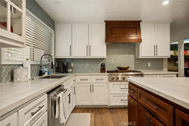 a kitchen with a sink stove and cabinets