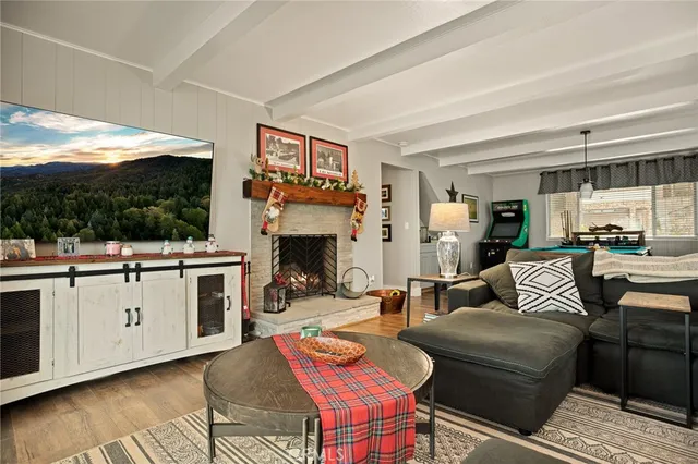 a living room with furniture a fireplace and a flat screen tv