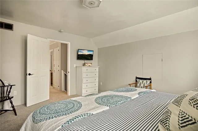 a bedroom with a bed and a television