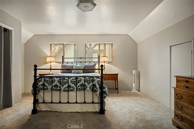 a bedroom with a bed and a tv