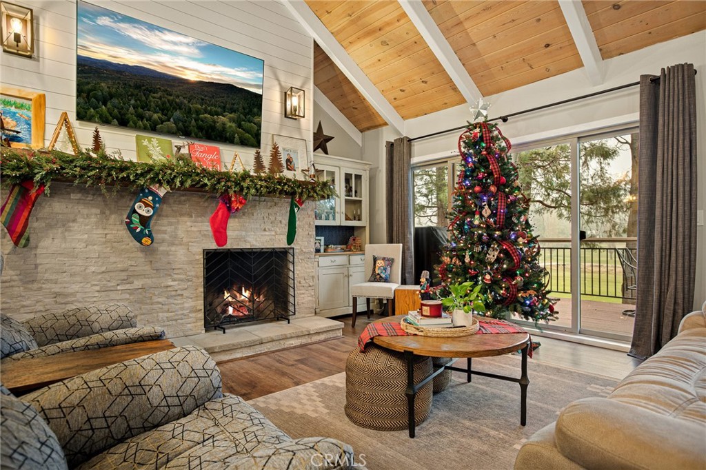 435 Riviera Drive Lake Arrowhead, CA 92352 - Photo 5 of 39 a living room with furniture a flat screen tv and a fireplace