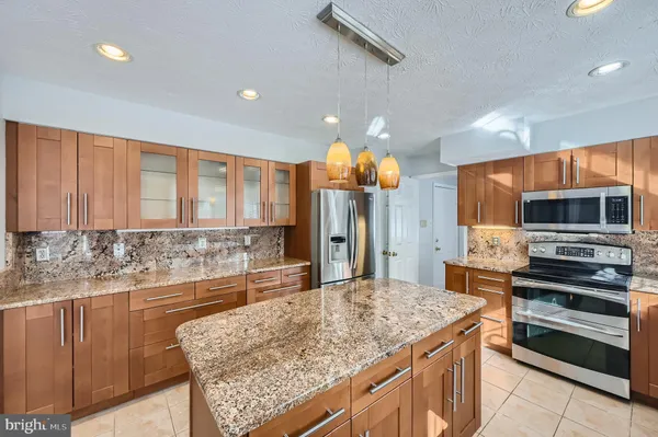 a kitchen with stainless steel appliances granite countertop a sink and cabinets